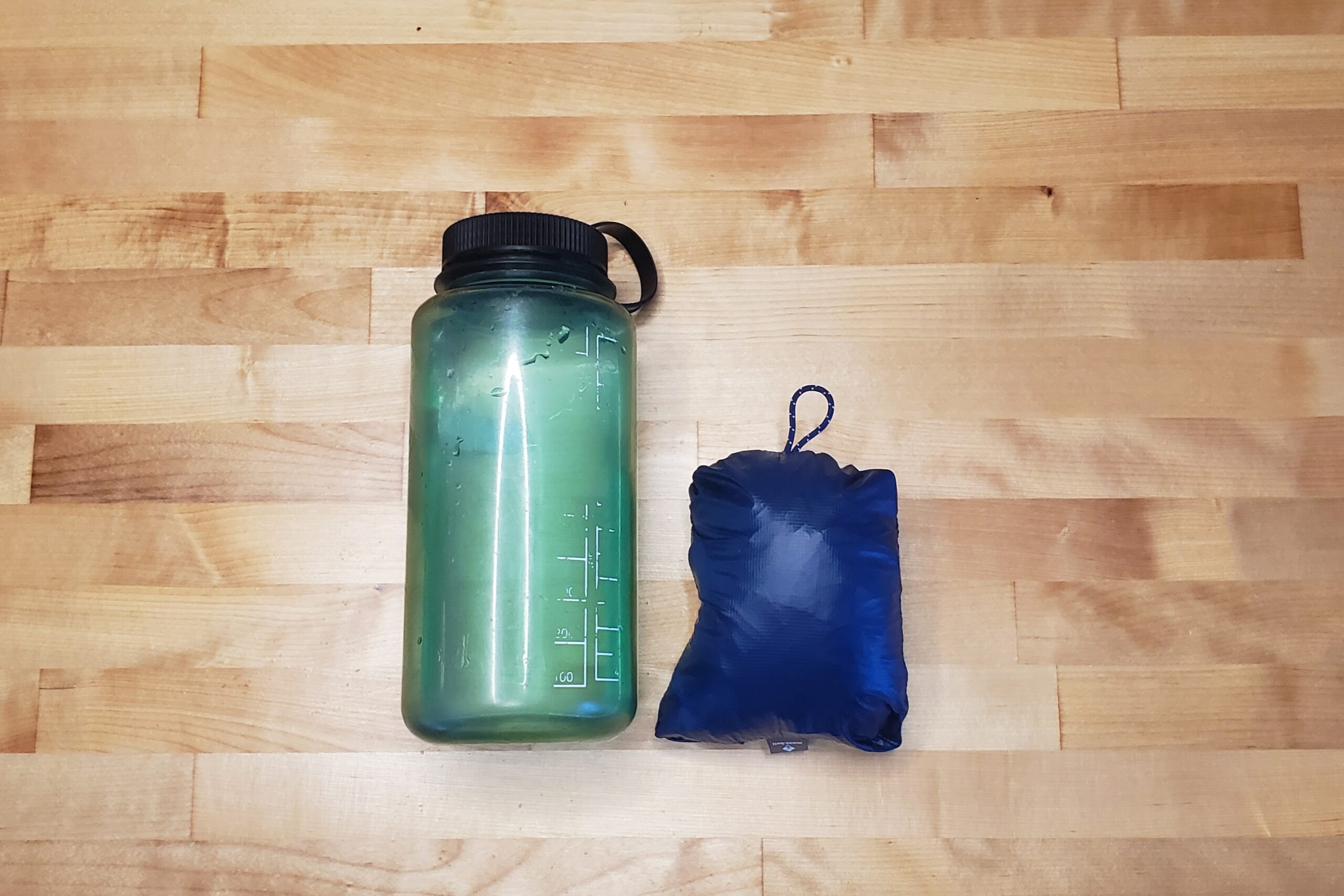 A packed jacket compared to a one liter bottle.