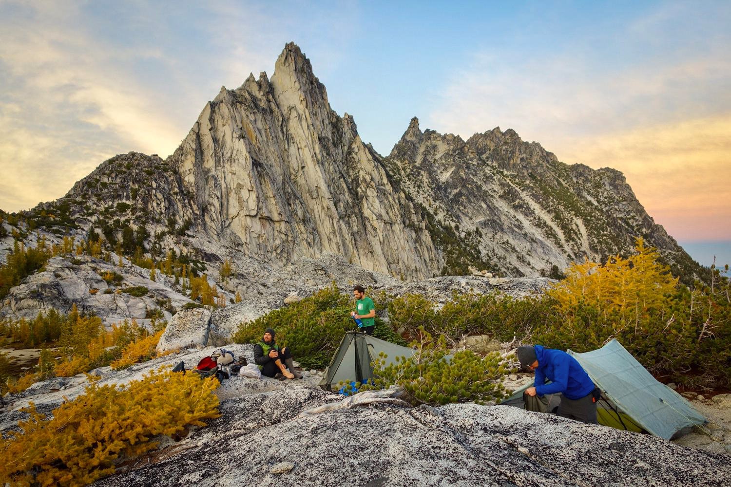 group in their rocky campsite at sunset in the fall