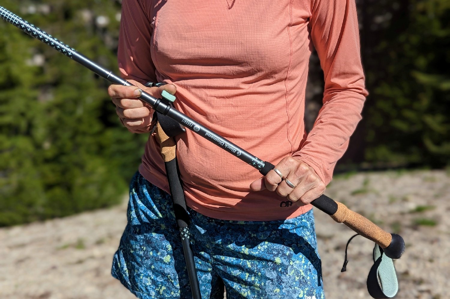 a woman adjusting her trekking pole