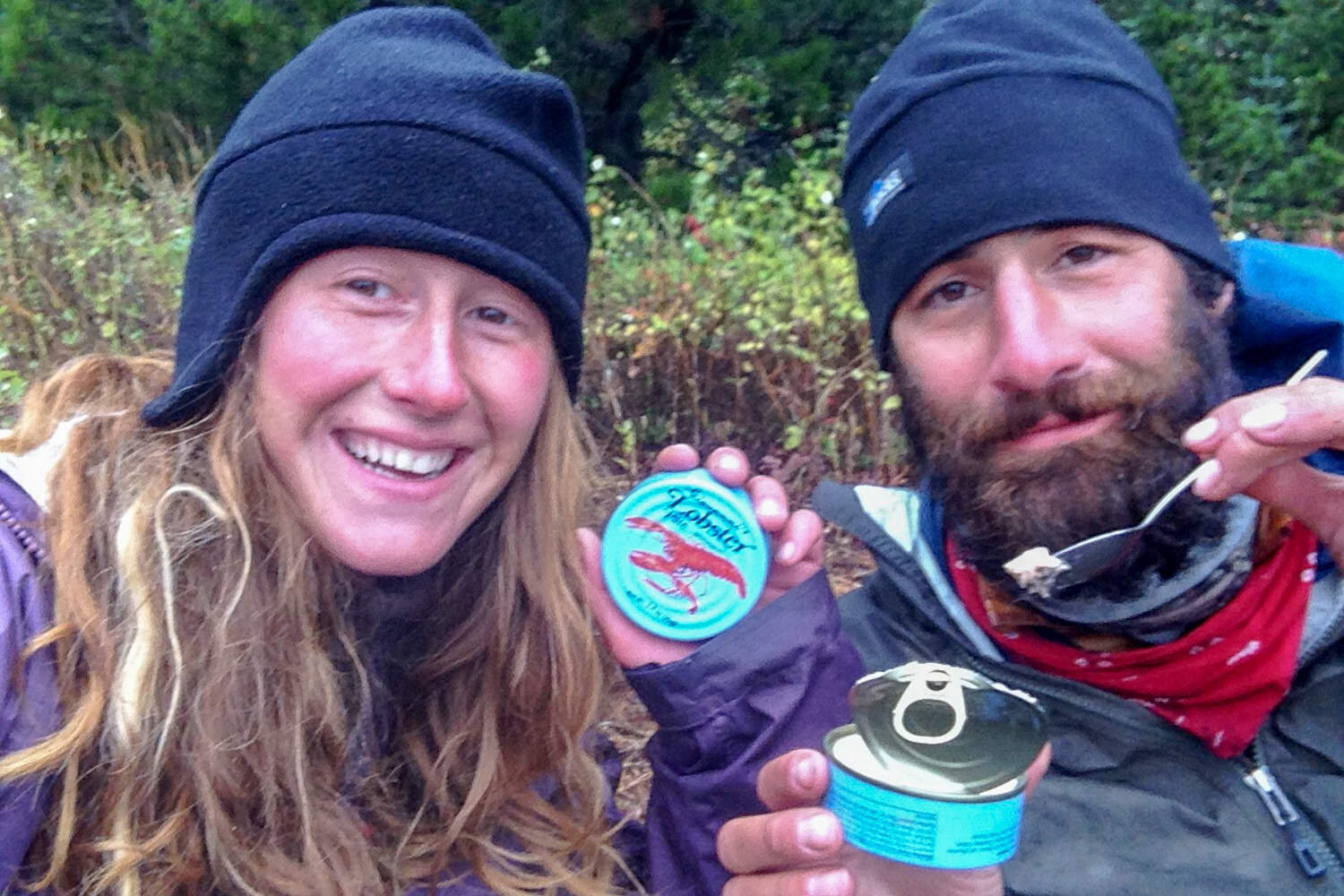 thru-hikers showing their canned lobster to the camera