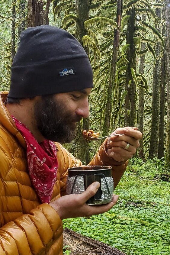 backpacker eating from a pot