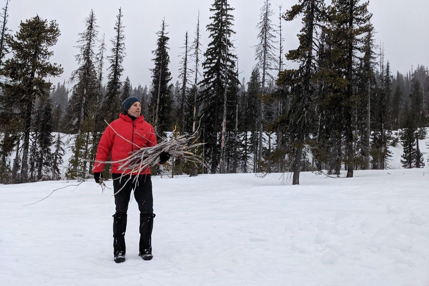 winter camper collecting sticks