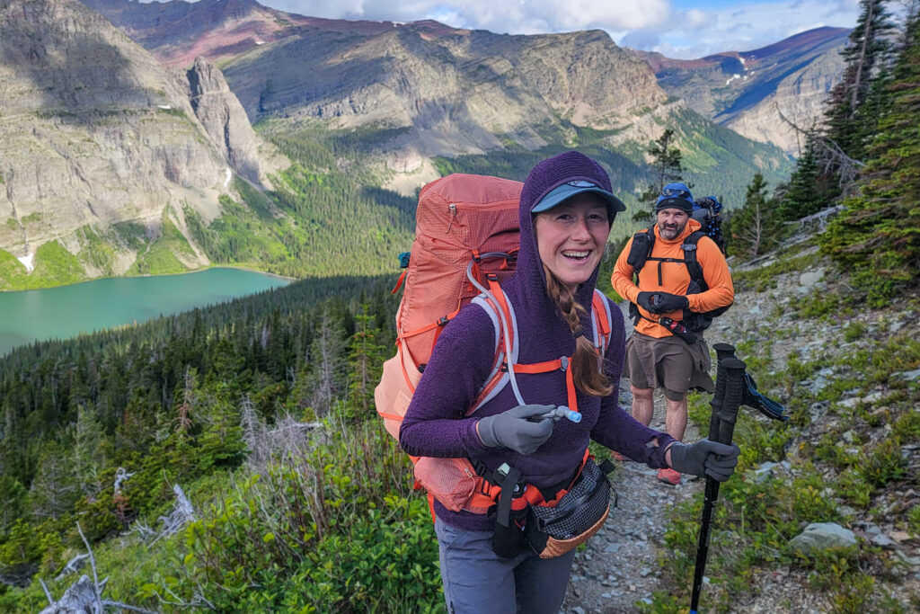A backpacker using the HydraPak Contour hydration reservoir with the Deuter Aircontact Core 65+10 SL