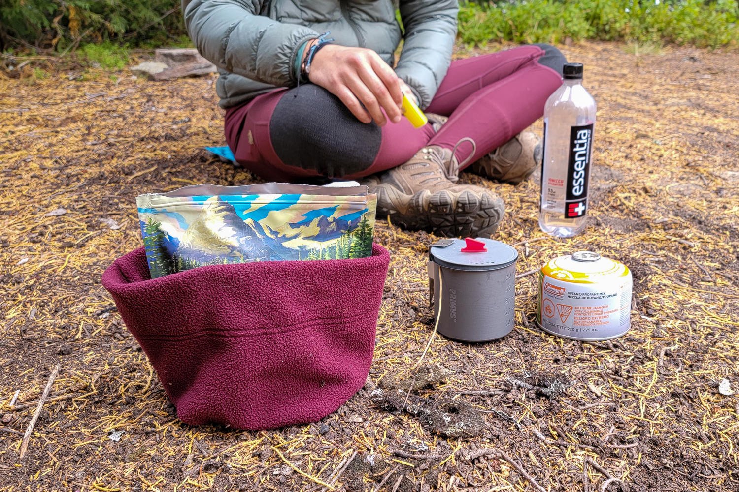 backpackers meal and kitchen kit set up on the ground