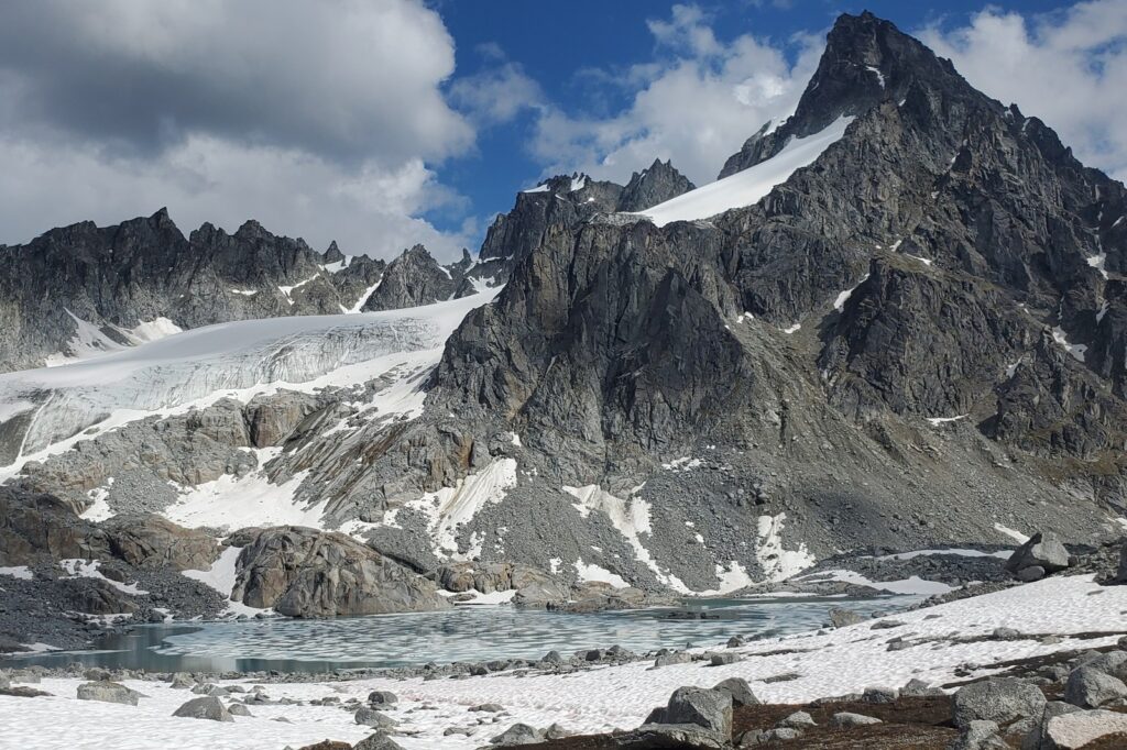A iced over lake with glacial background.