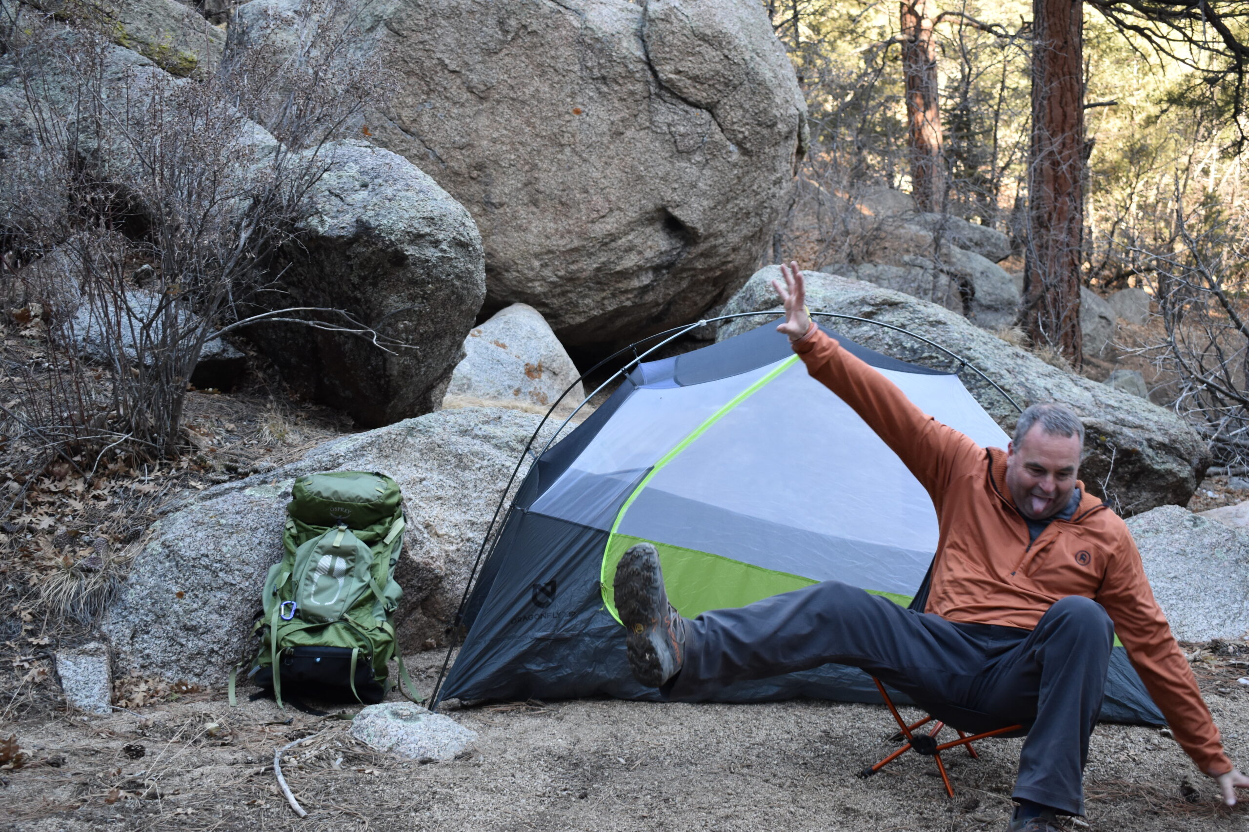 Our male gear analyst falling off the Flexlite Air Chair while taking a picture in a desert canyon campsite