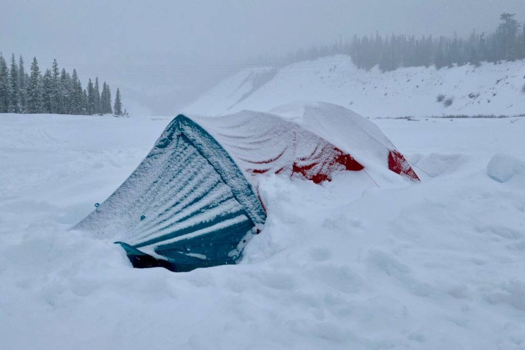 The Mountain Hardwear Trango2 4-season tent covered in snow on a winter camping trip