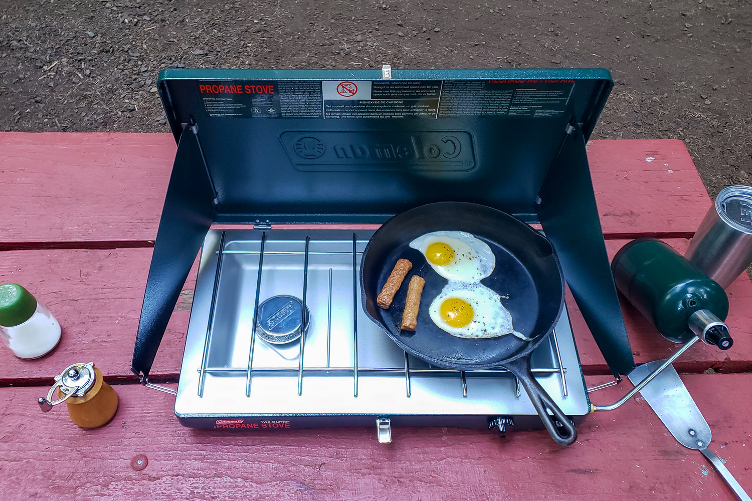Top-down view of a cast iron skillet on the Coleman Classic Camping Stove